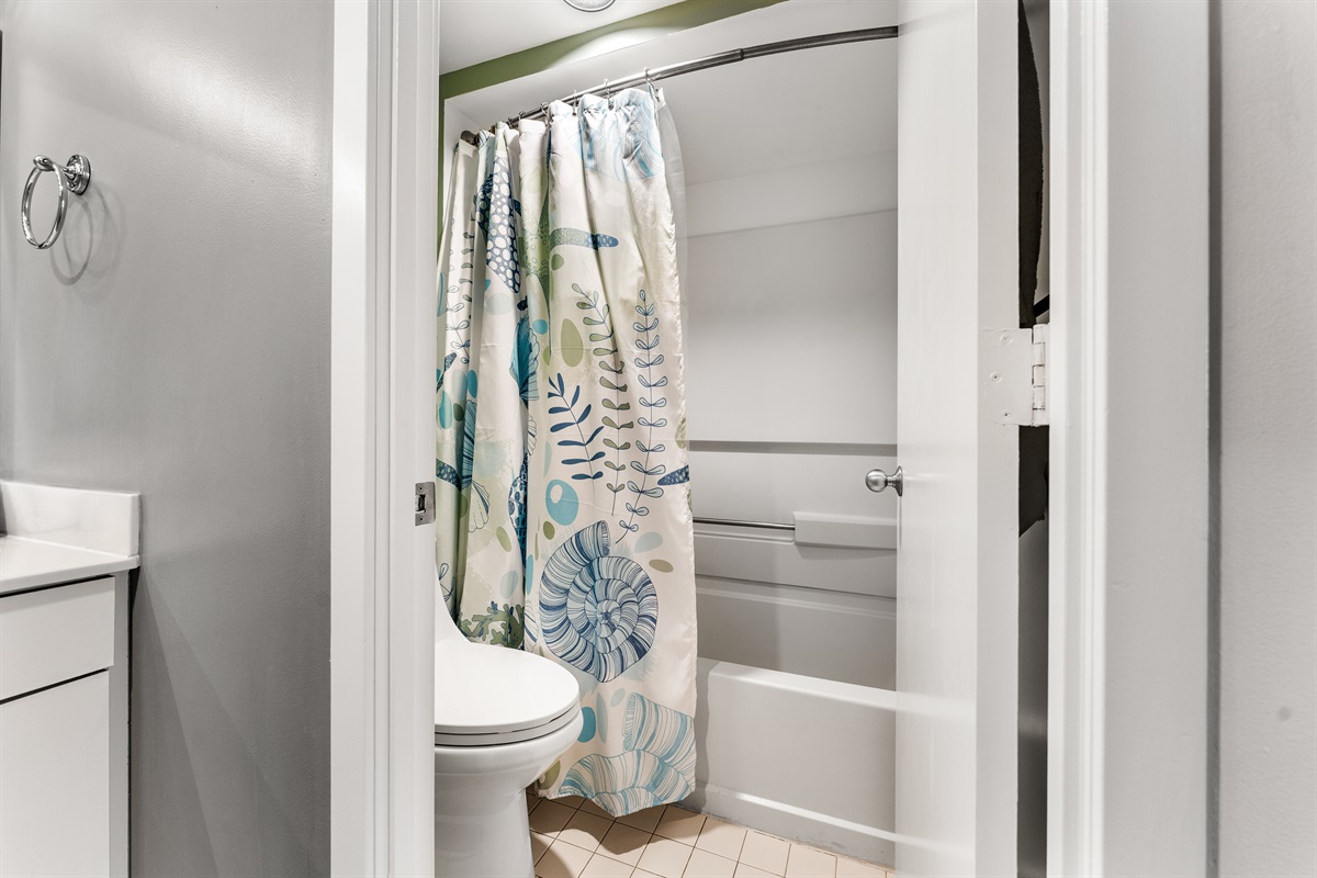 Main bathroom with double sinks, seperate toilet and tub/shower room