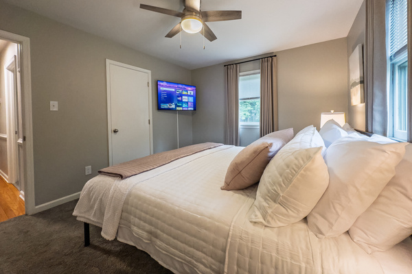 King bed, 55" Smart TV, ceiling fan, two led light nightstands with multiple charging ports, two multi light function lamps, blackout curtains, dual closets.