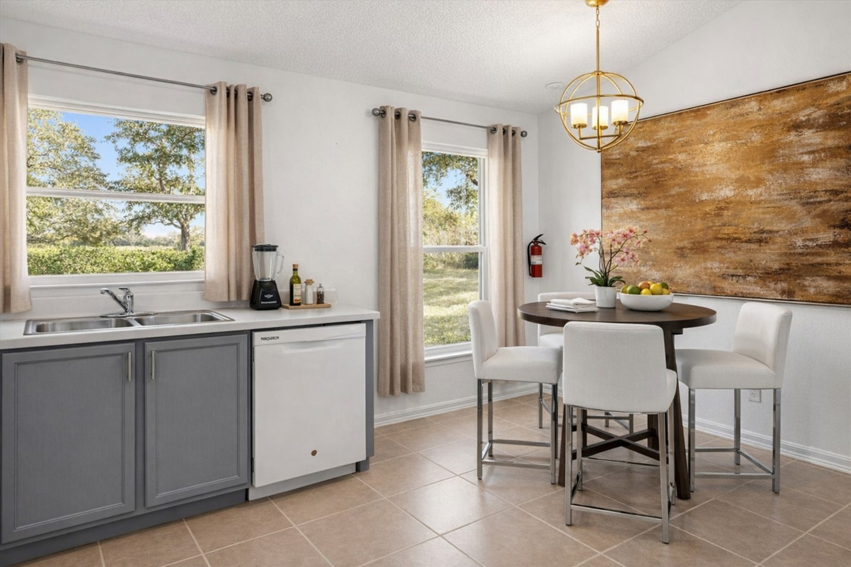 Bright kitchen with large windows and seating for for at kitchen table