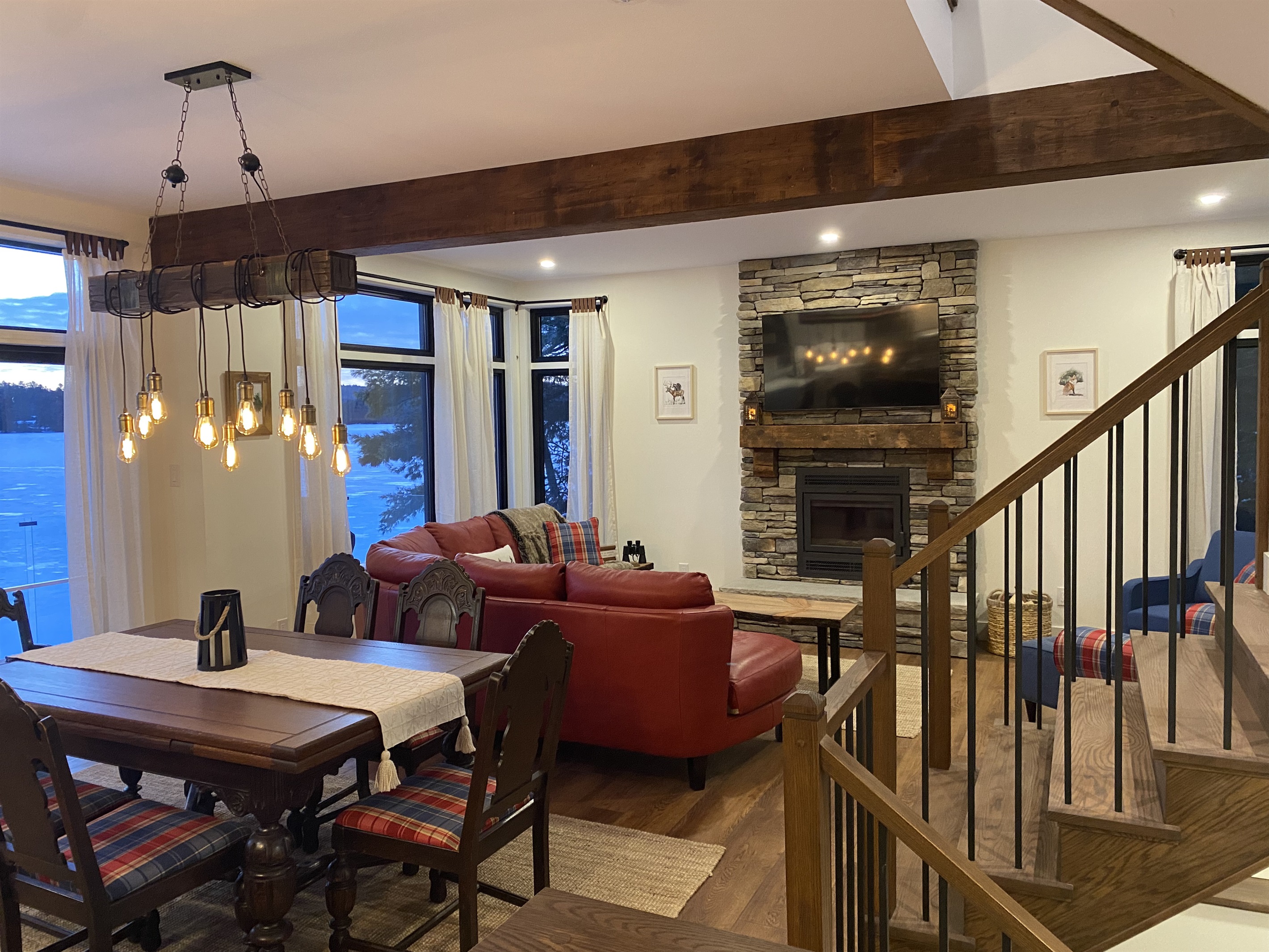 Dining room with living room, expansive living room seating and wood-burning fireplace 