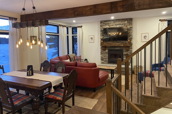 Dining room with living room, expansive living room seating and wood-burning fireplace 
