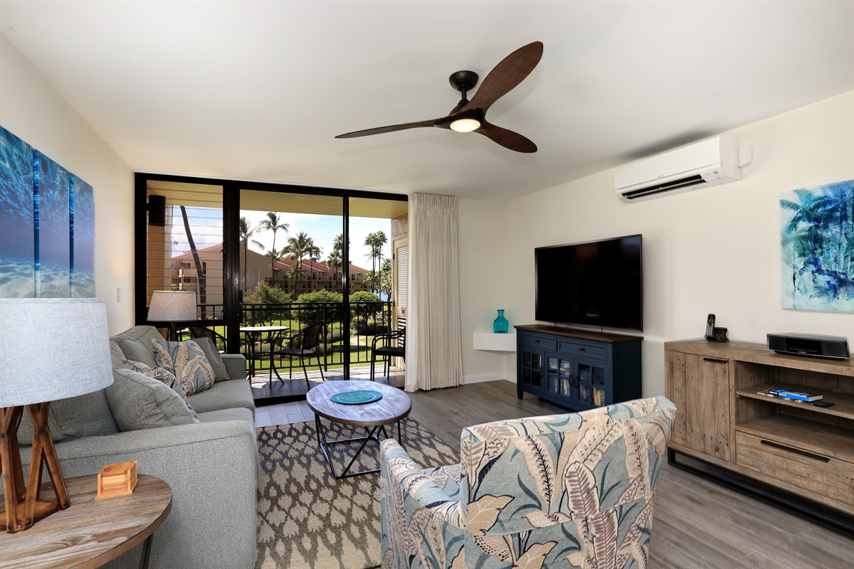 Spacious living room with large TV, split-system A/C