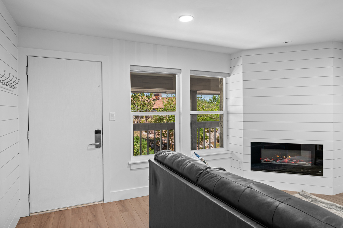 Cozy main-level living space with fireplace and easy access to the balcony.