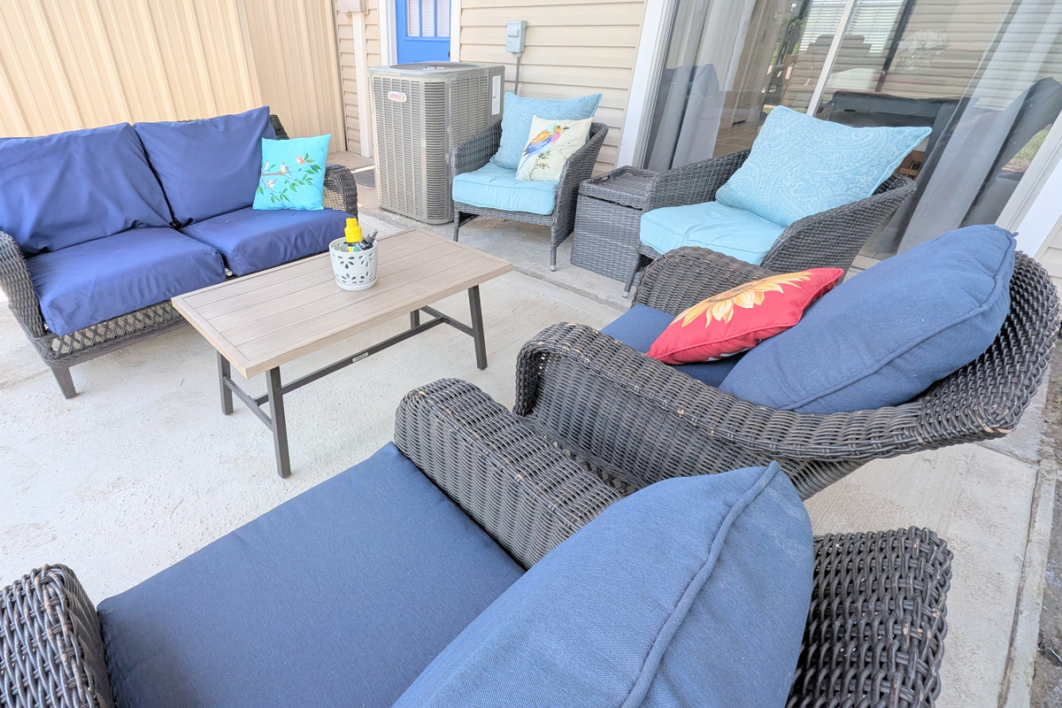 Relax on the covered patio with plush seating and a fenced courtyard for added privacy.