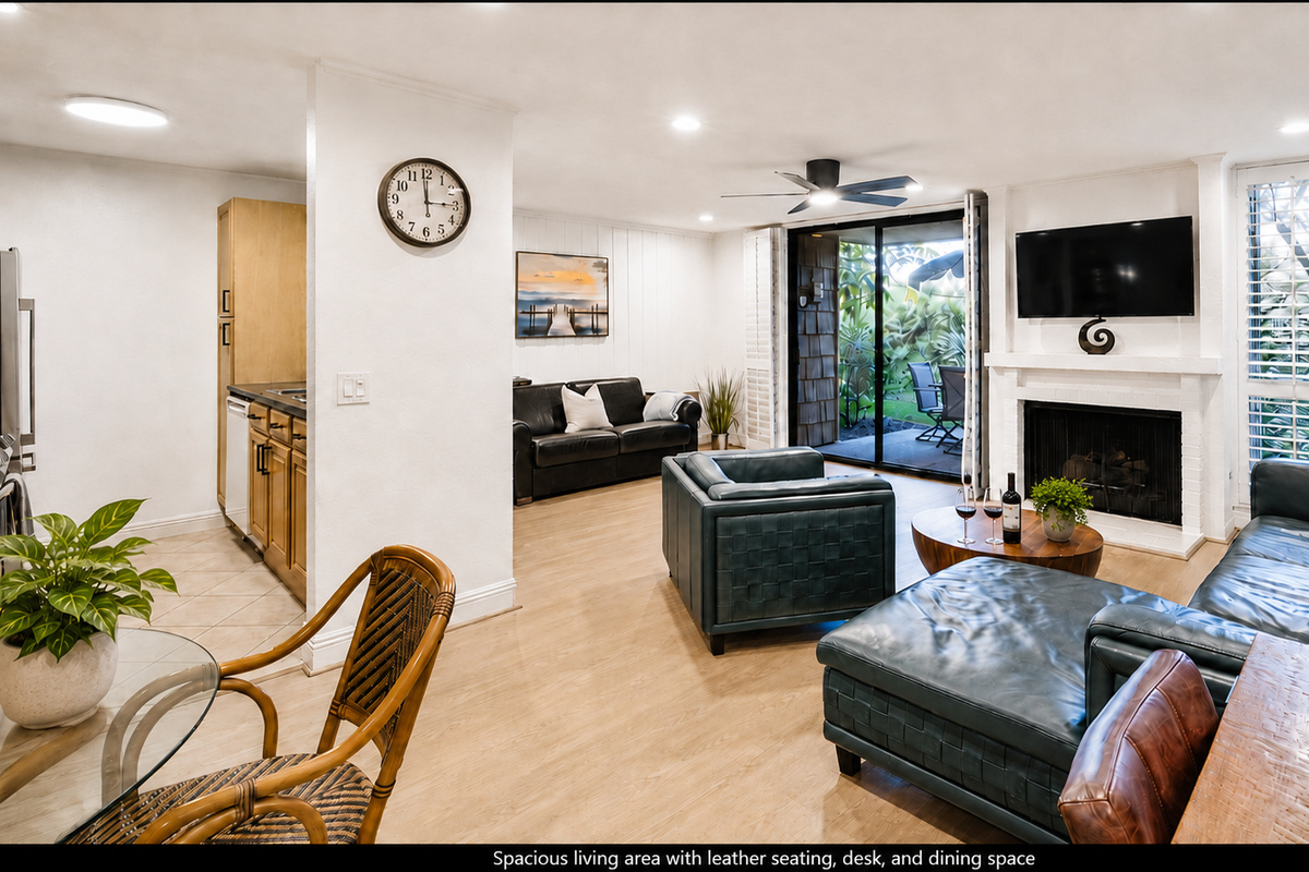 Spacious living area with leather seating, desk, and dining space