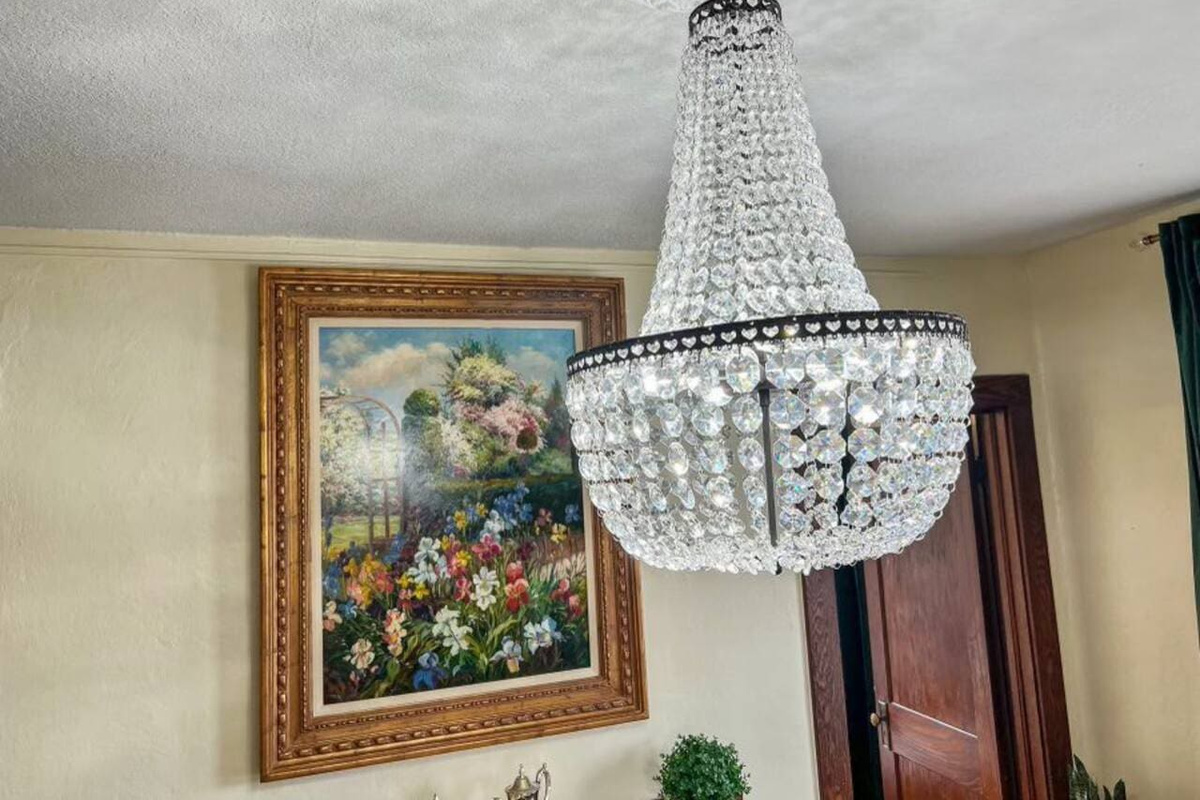 Elegant chandelier hanging above the dining table, adding a touch of sophistication and ambiance to your meals.