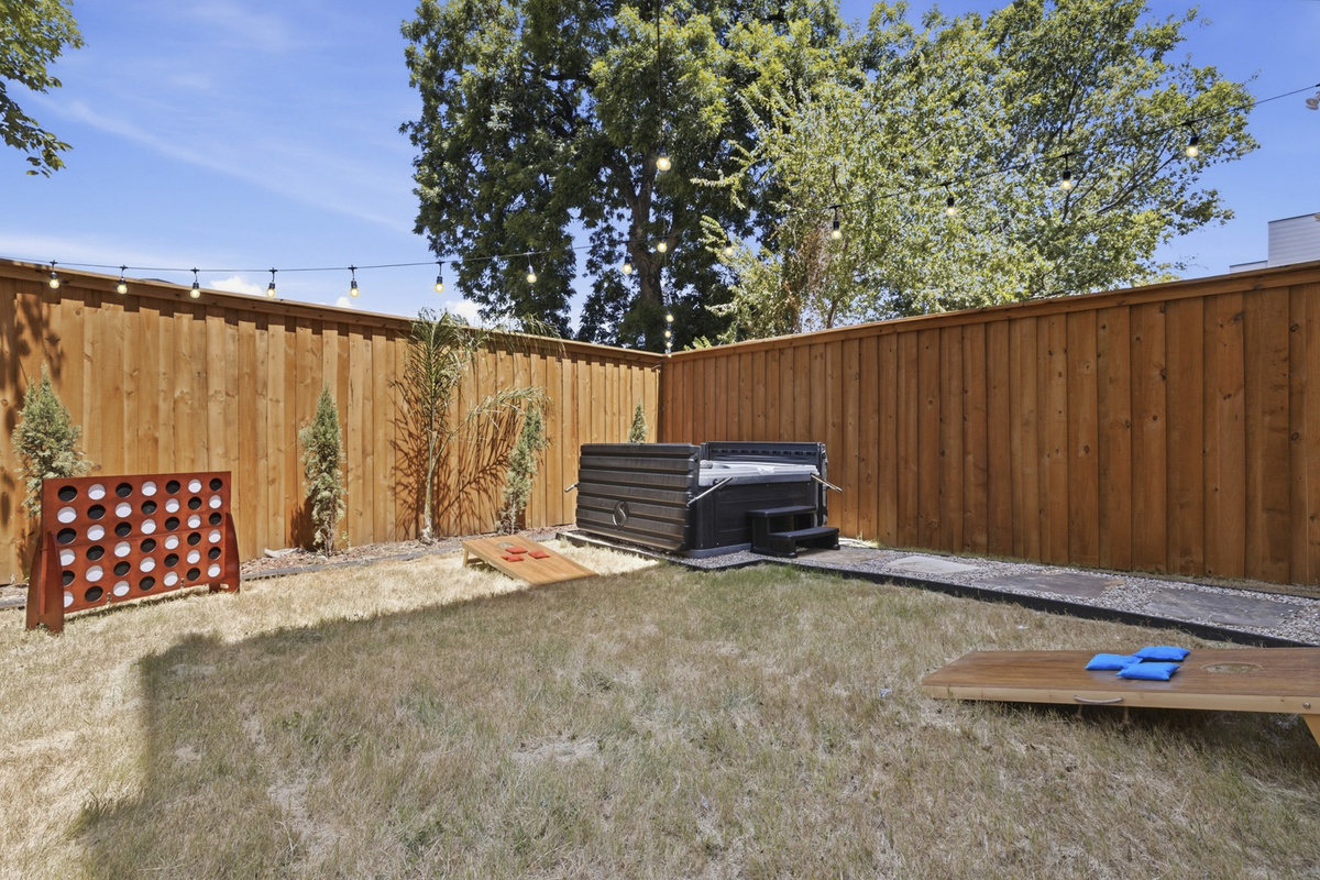 Unwind in your private yard with a hot tub and playful games under the twinkling lights!