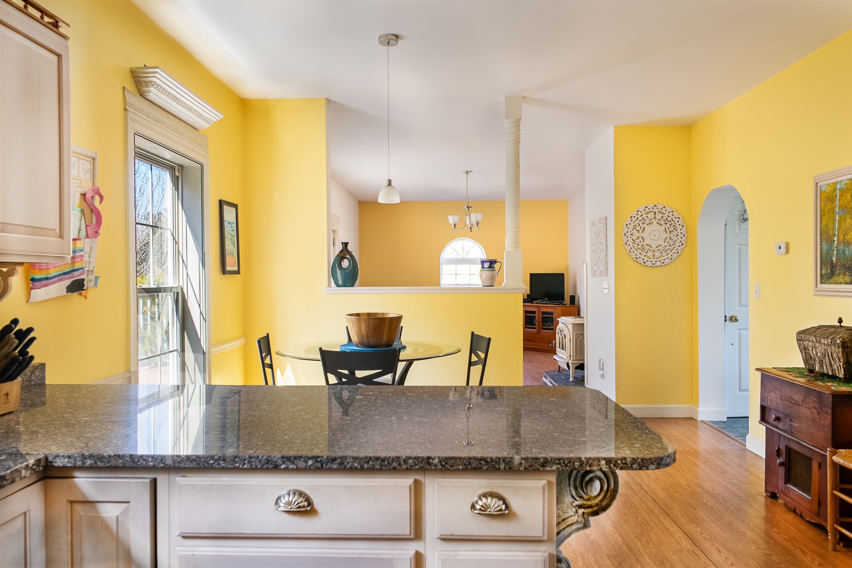 Experience the open-concept design of Seven Peaks Ridge. This view from the kitchen through the breakfast nook into the main living room ensures the group stays connected, whether you're grabbing a quick bite or relaxing after a day in Acadia.