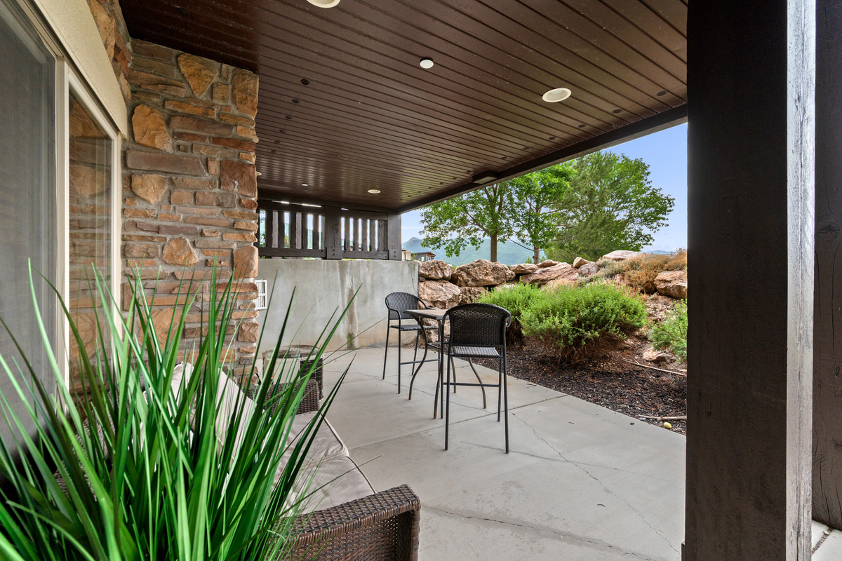 Covered lower patio offers a quiet outdoor retreat surrounded by the natural beauty of Lakeside Village.