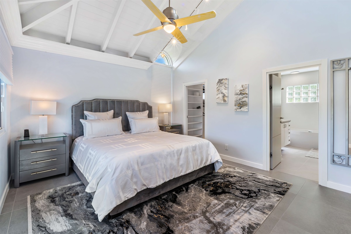 Primary bedroom with king bed and ensuite bathroom