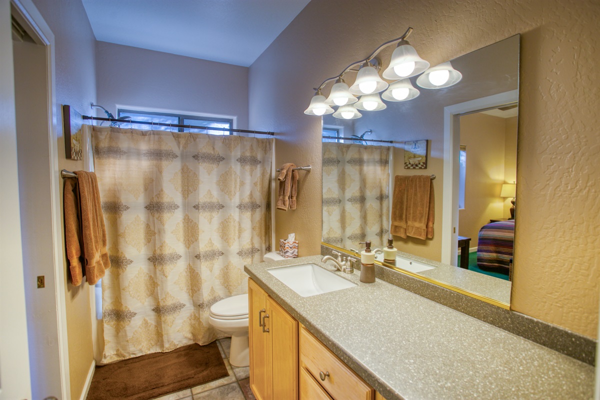 Clean, bright second bathroom with convenient tub and shower combo.