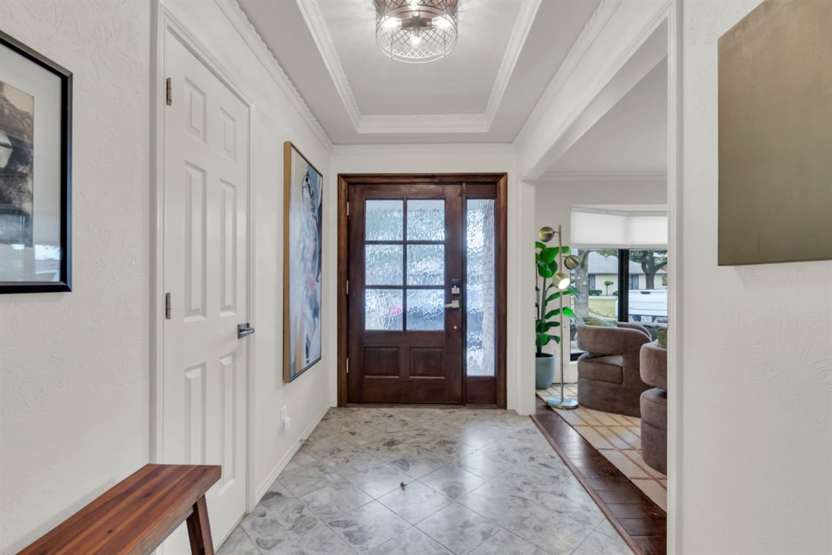 Elegant entryway that sets the tone for the home, featuring a welcoming design and a smooth transition into the open living spaces beyond.