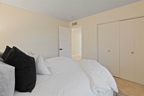 Guest bedroom with closet storage and a comfortable sleeping setup