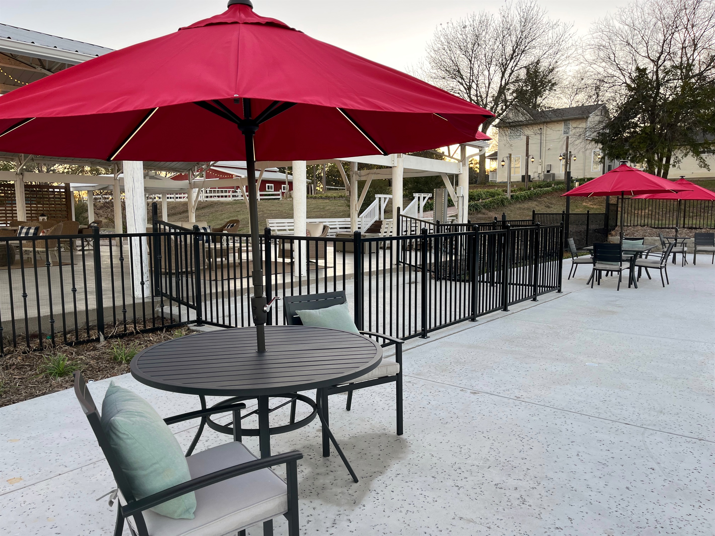 Seating behind the safety fence for poolside chats in the shade of an umbrella