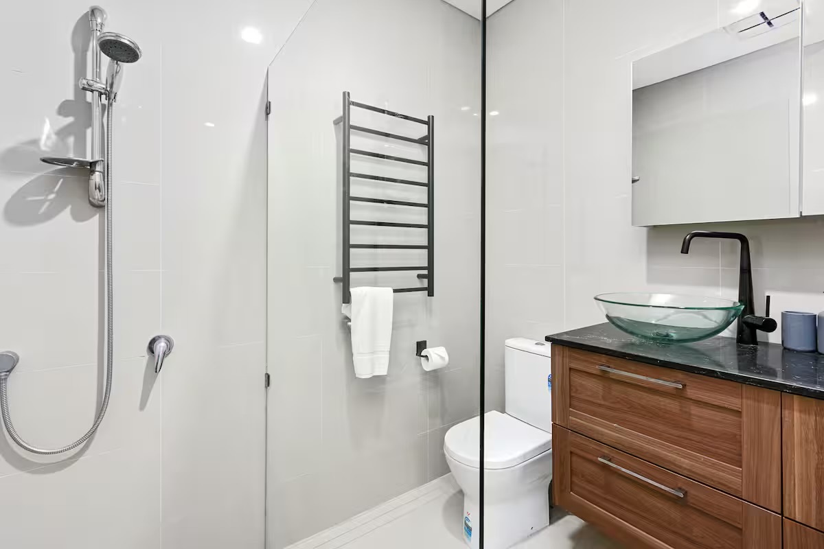 The bathroom includes a glass-screen shower, toilet and vanity area, giving Sasha’s Cottage on the Hill the essentials for daily routines.