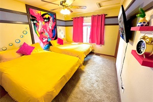 Generous bedroom with two cozy queen-sized beds, ideal for a restful and comfortable stay