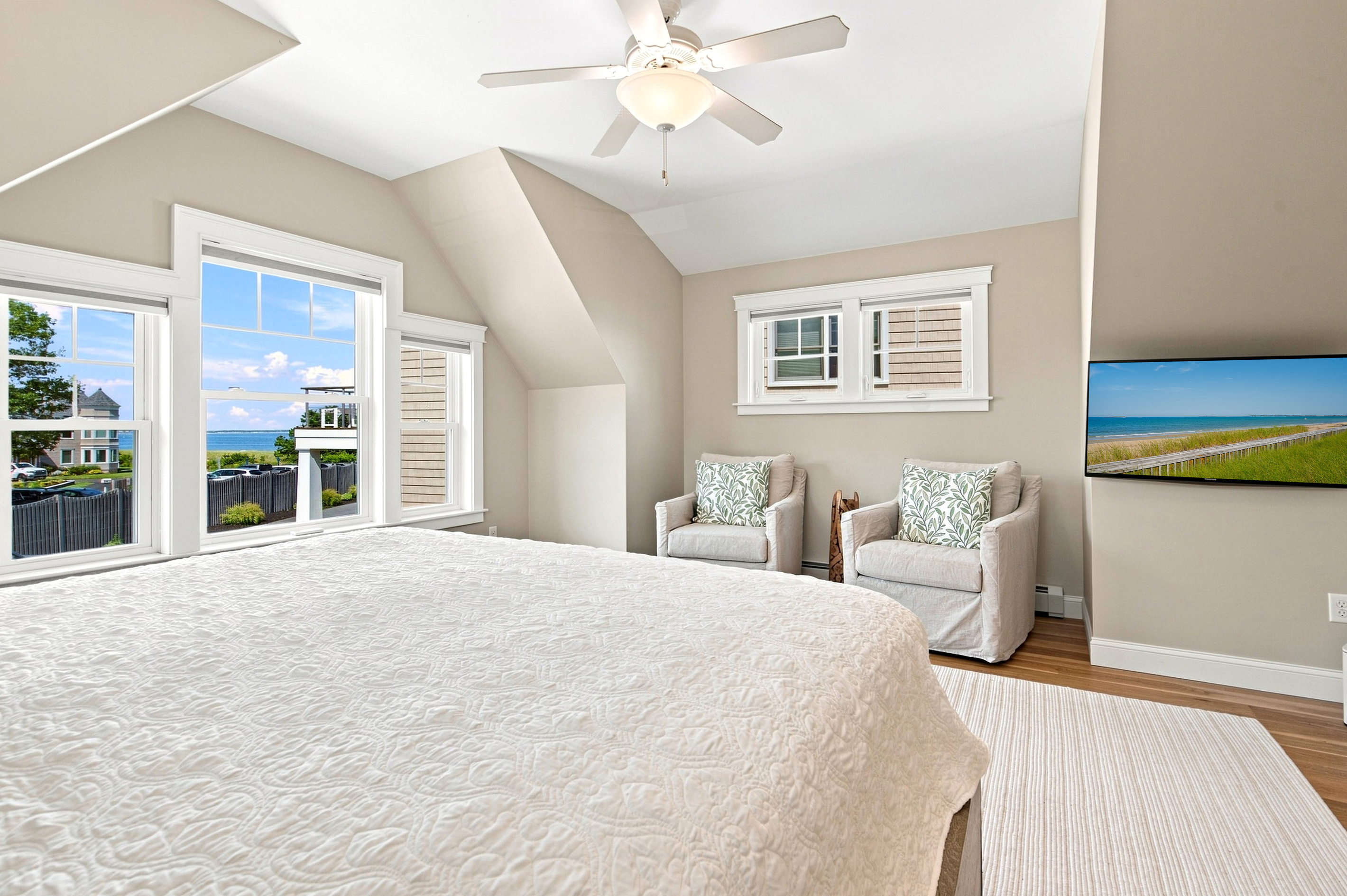 Wake up surrounded by natural light in this bright bedroom with a comfortable sitting area for added relaxation.
