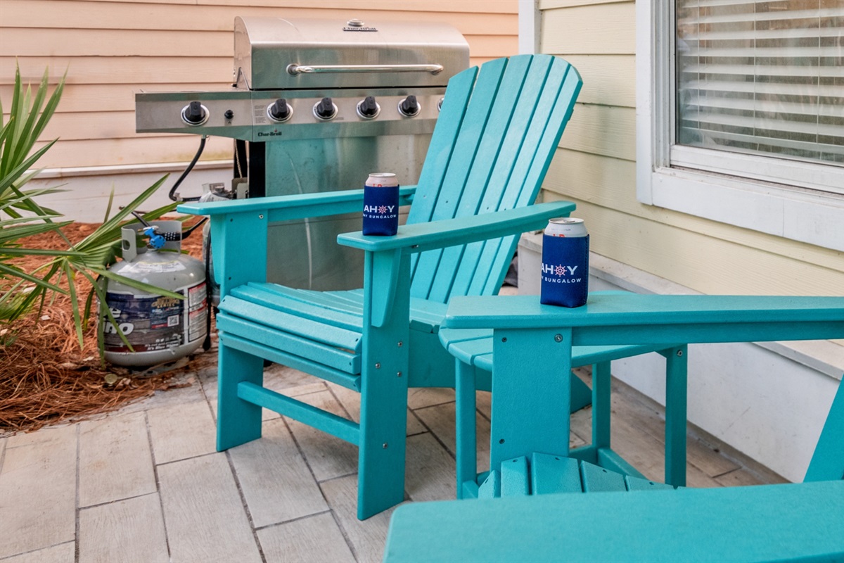 Two chairs, two koozies, and a grill at the ready.