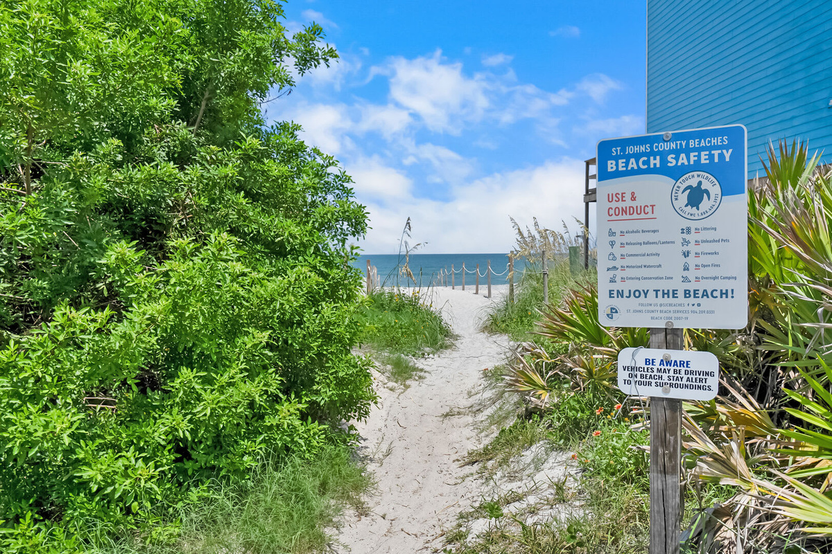 The sandy path down to the beach, with the county safety sign at the head of it. Check the flags before you swim, and then go and enjoy some of the emptiest sand you will find in all of northern Florida.