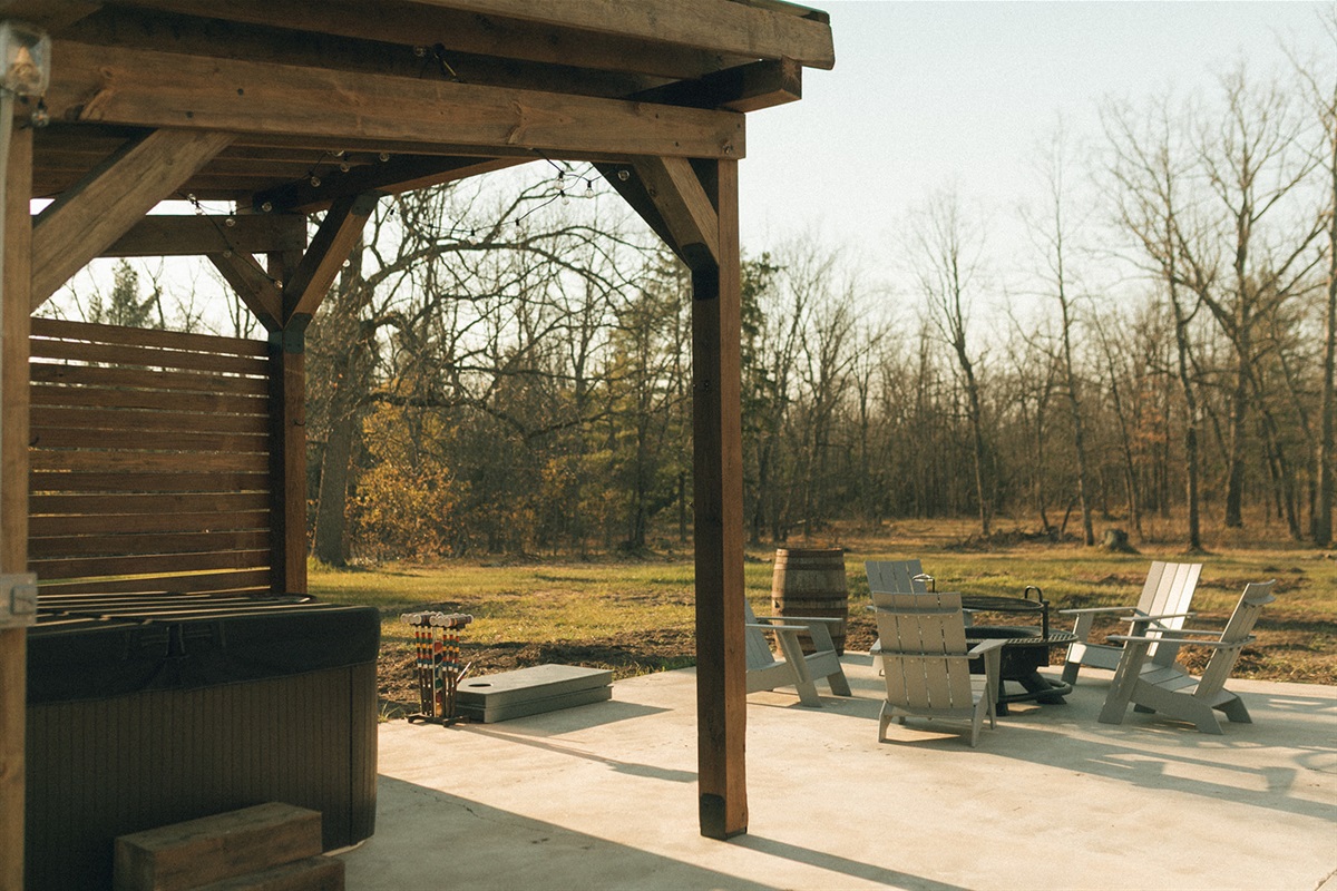 Hot tub overlooking the large backyard and firepit
