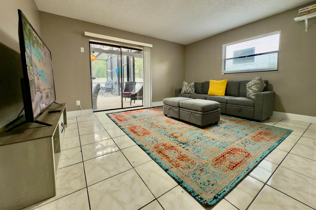 This spacious lounge-style living room is designed with comfort, color, and entertainment in mind.