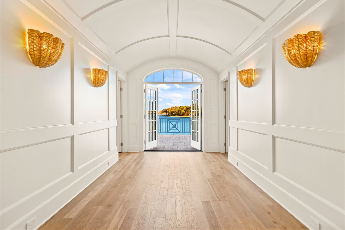 Grand entry hallway with arched ceiling and warm natural light.