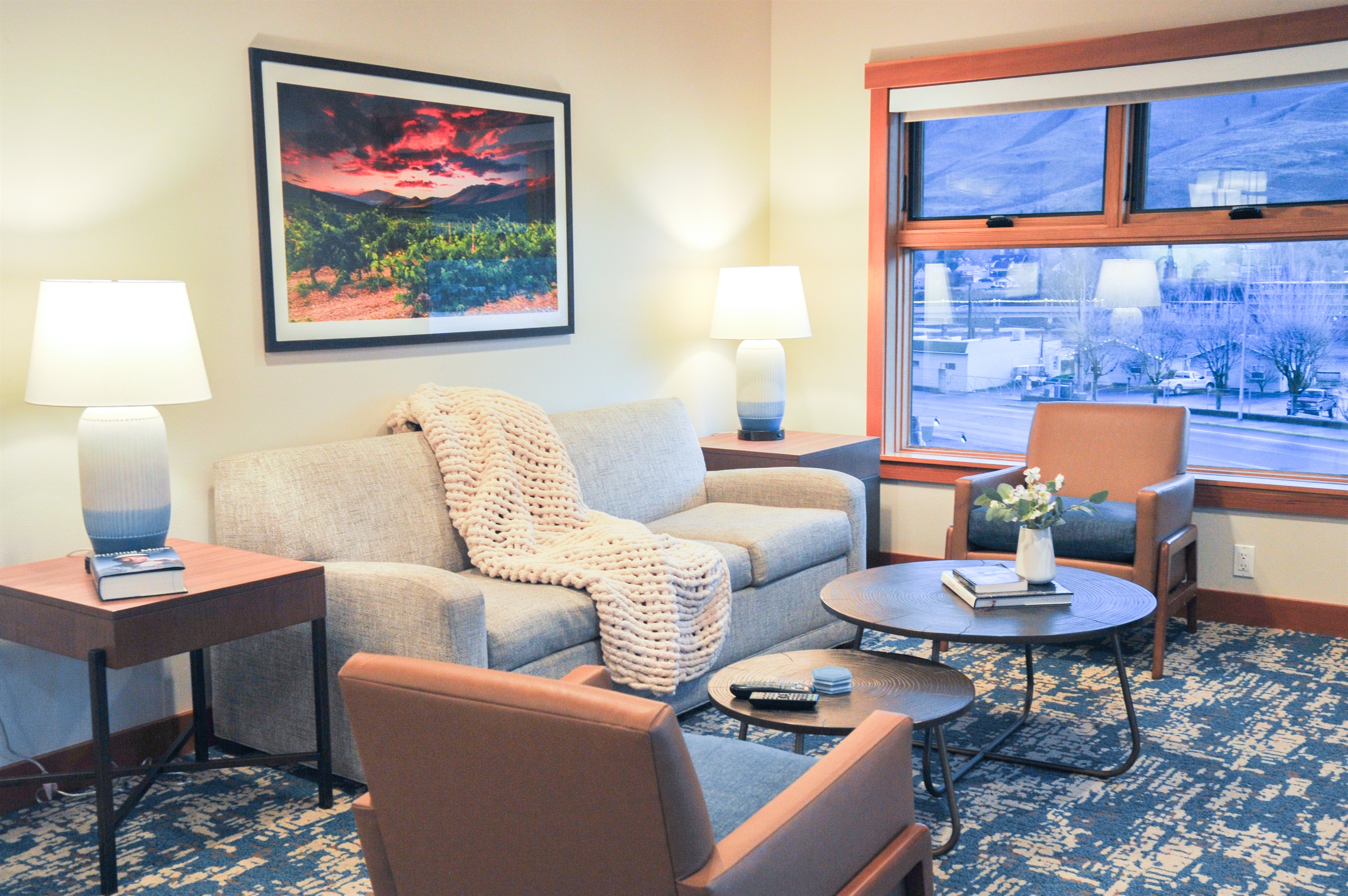 Open living room with TV, fireplace, lake view and with pull out couch