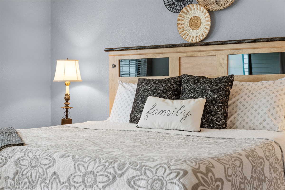 Layered bedding and soft finishes make the king bed feel especially inviting.