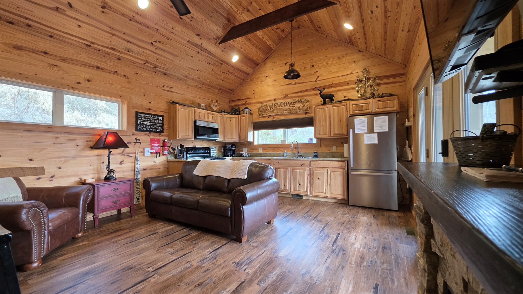 Large open living room and kitchen with ceiling fans