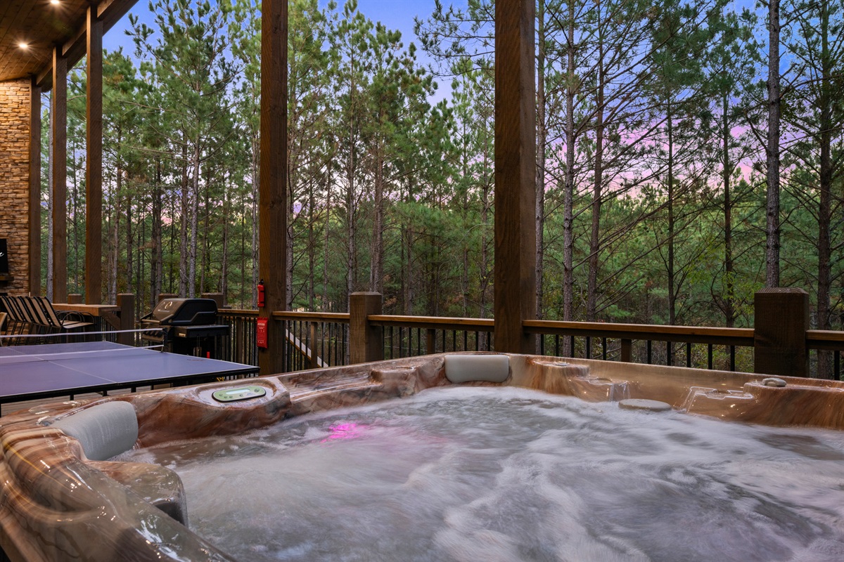 Soak your cares away in the hot tub, complete with peaceful wooded views and twinkling lights for the perfect evening escape.
