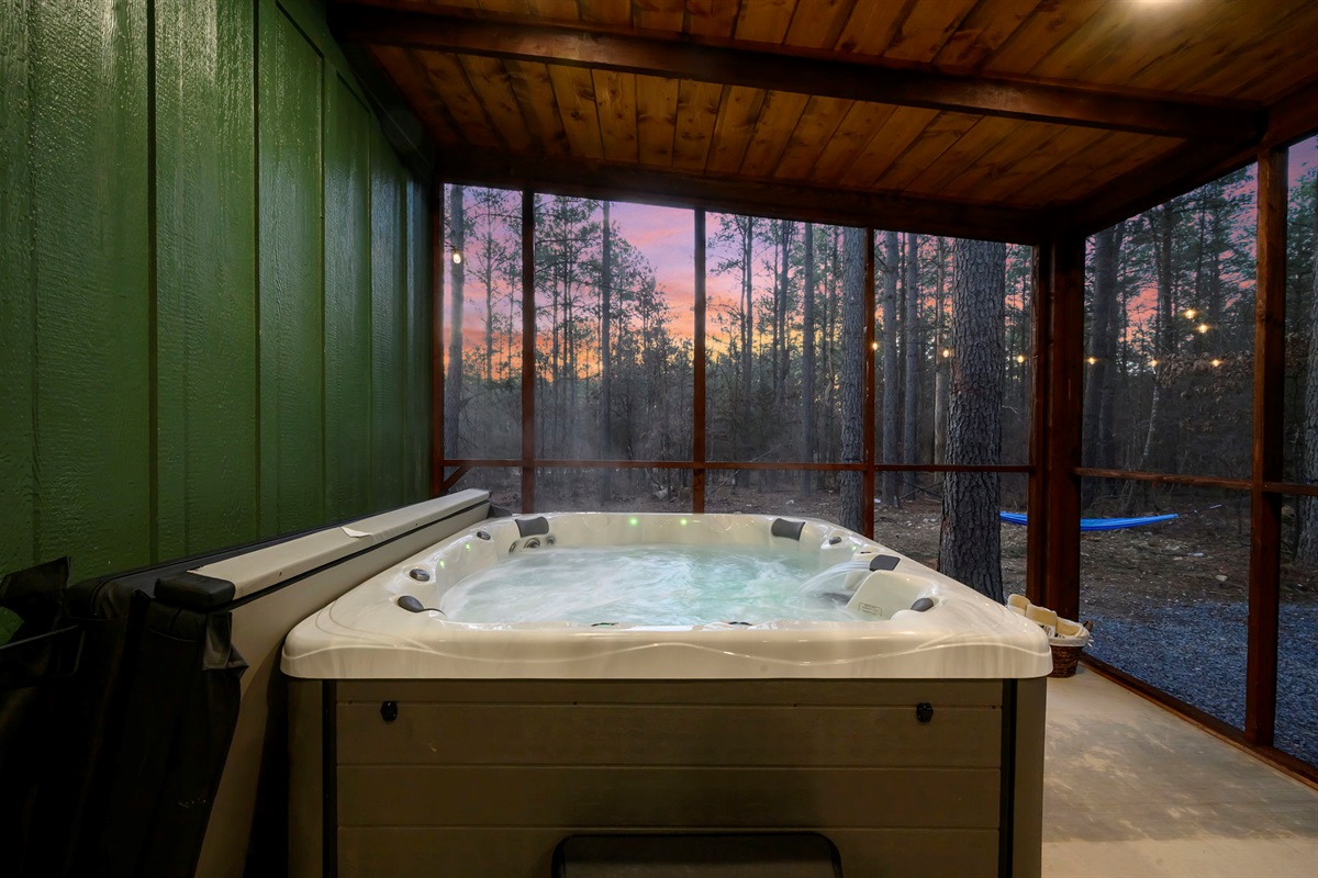Soak in the private hot tub while enjoying peaceful wooded views.