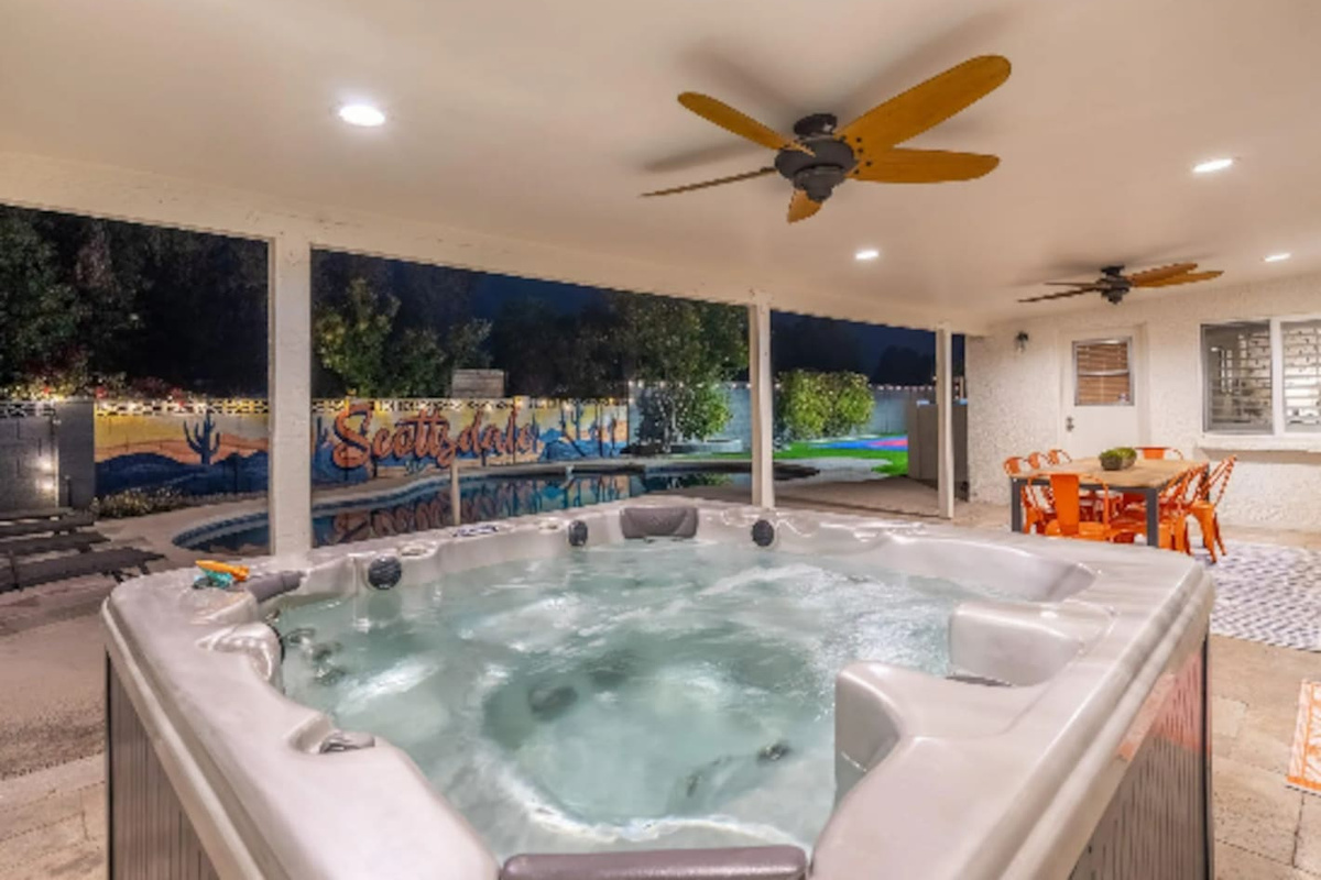 A private hot tub tucked under the patio, poolside views included, made for winding down after a long day in the sun.