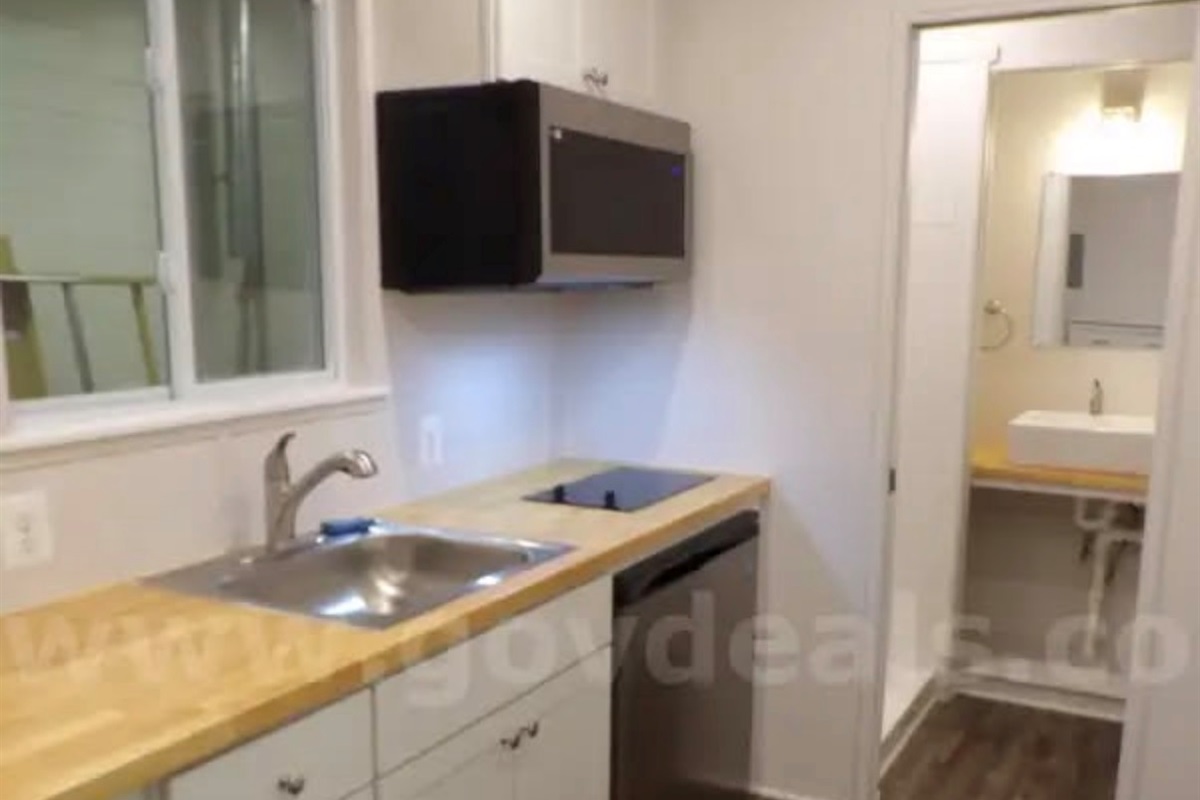 Kitchen with fridge/freezer combo, microwave and cooktop