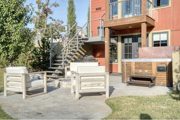 Lower Level outdoor area with fire pit, hot tub & gas grill.