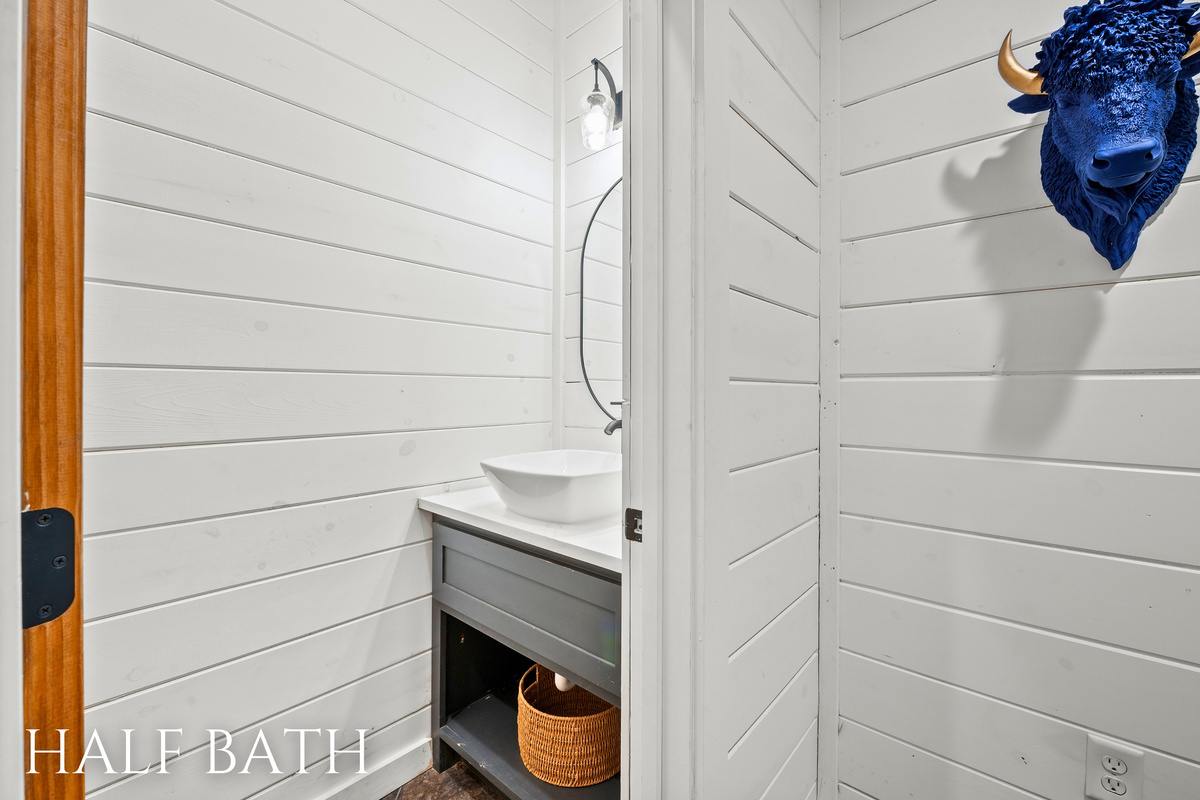 A modern and stylish half bathroom tucked away in the laundry room with clean lines and charming details.