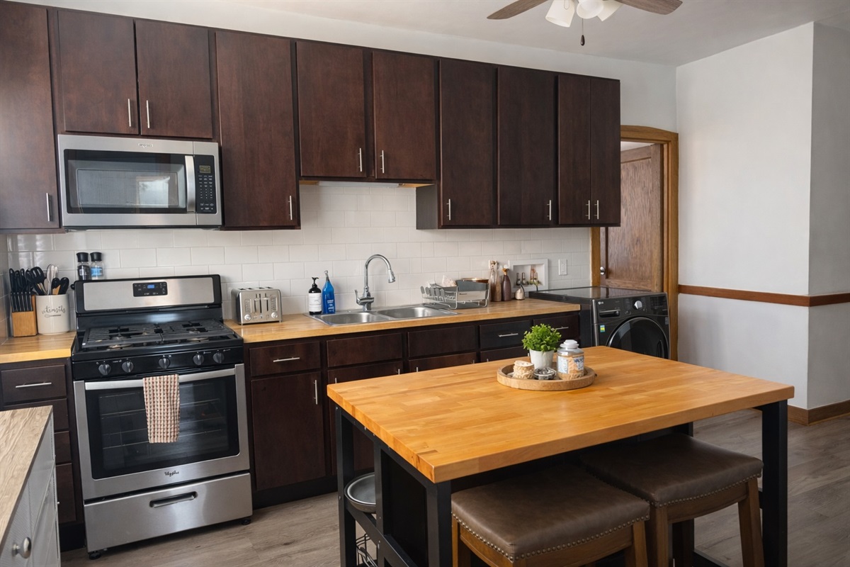 Fully equipped kitchen with stainless appliances, cookware, and pre space, ready for everything from coffee to full meals.