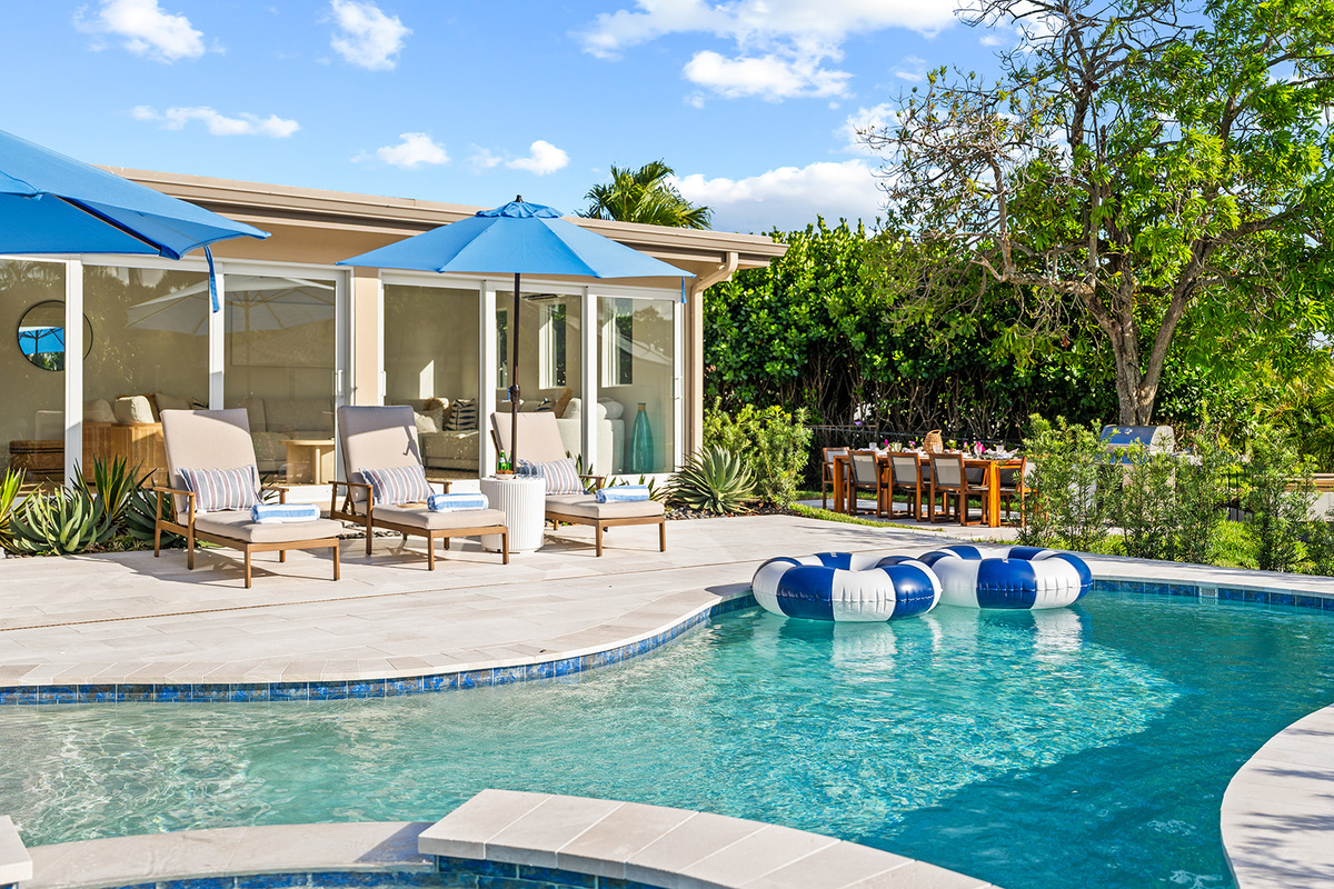 The spacious pool deck offers plenty of room to relax, gather, and enjoy the beautiful waterfront setting.