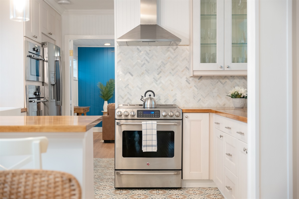 The heart of the home - gather around the island, cook together, and make memories in this airy, coastal kitchen