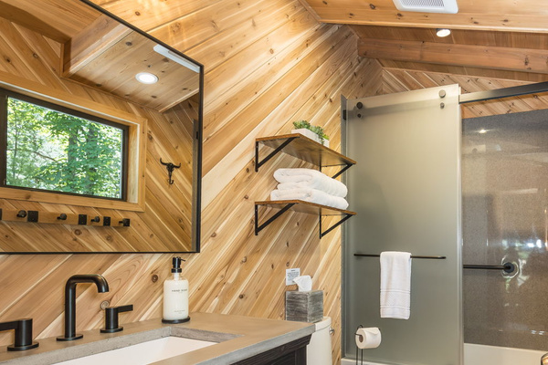 Second full bathroom with bathtub and shower combination.