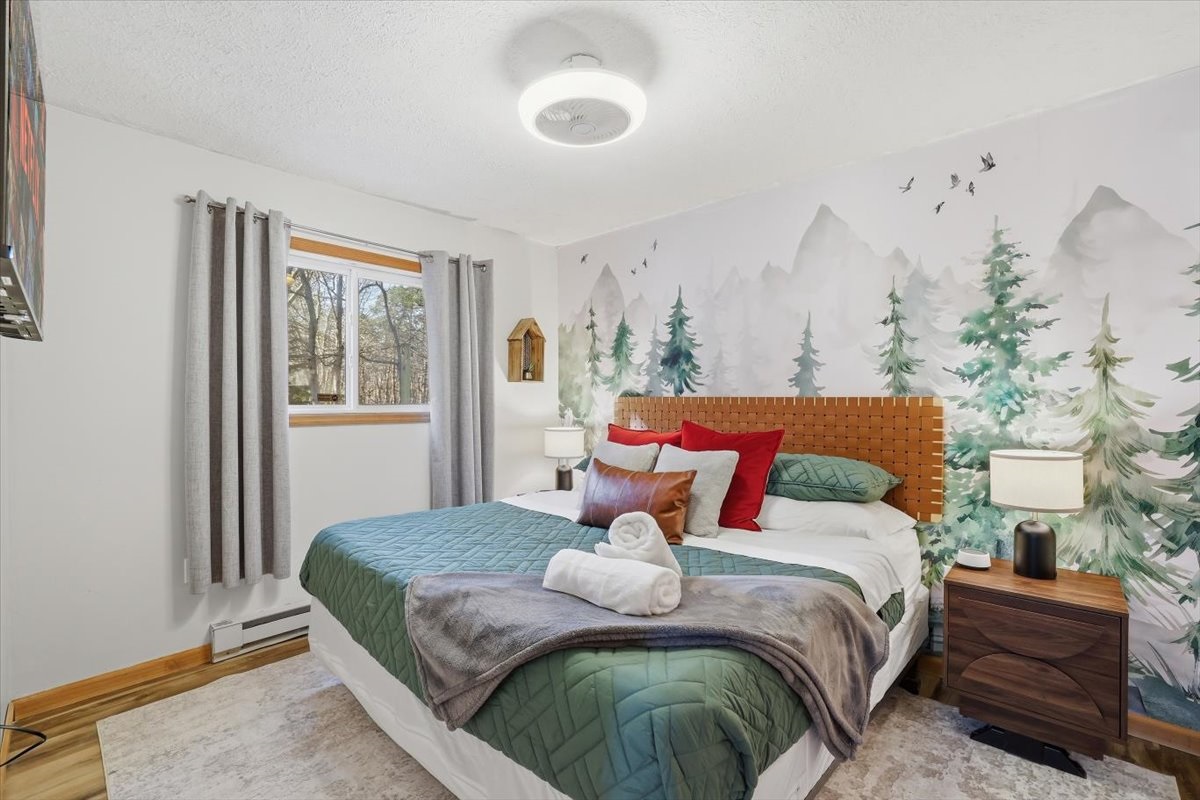 The downstairs king bedroom designed for the kind of deep, unhurried sleep you actually came to find