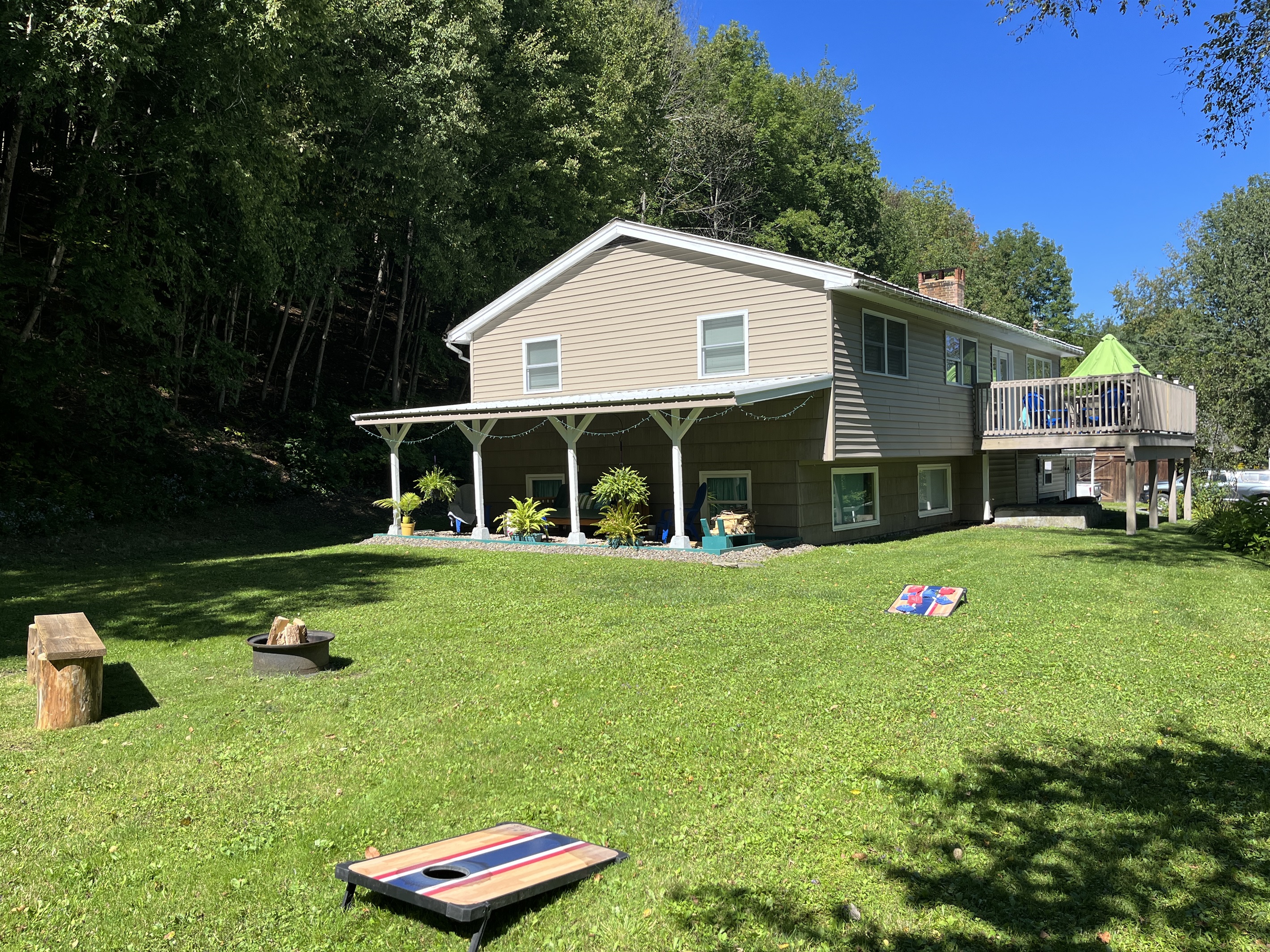 Cornhole, firepit and covered outdoor hangout space