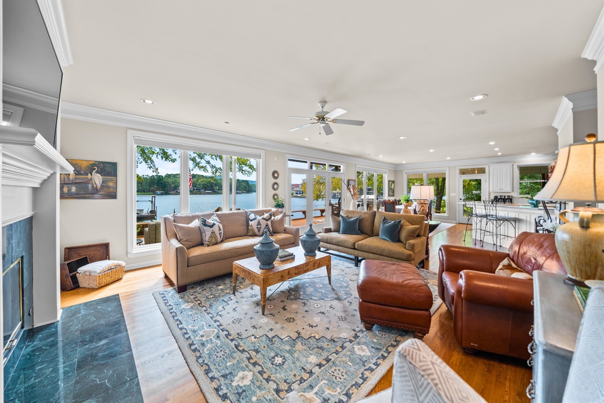 Enjoy lake views from the comfort of the living room &mdash; surrounded by warmth and soft seating.