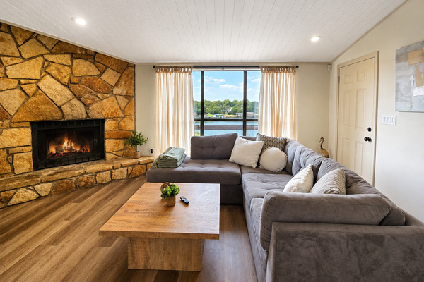 Open living room with fireplace and panoramic lake views.