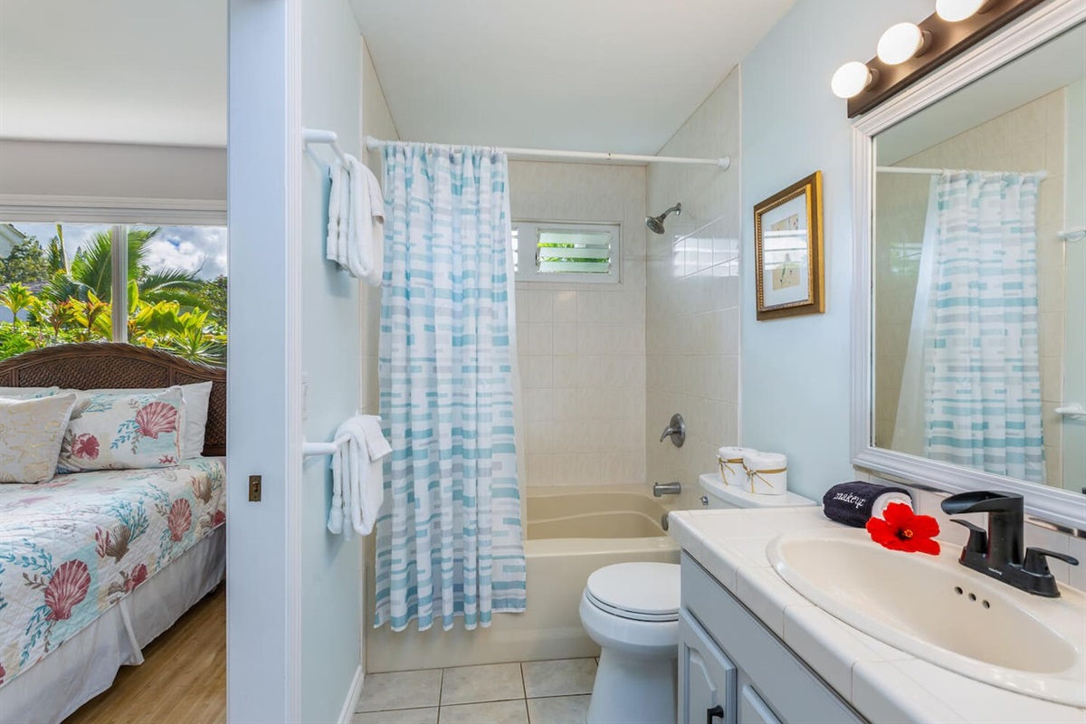 Pineapple Suite attached bathroom with shower and bathtub.