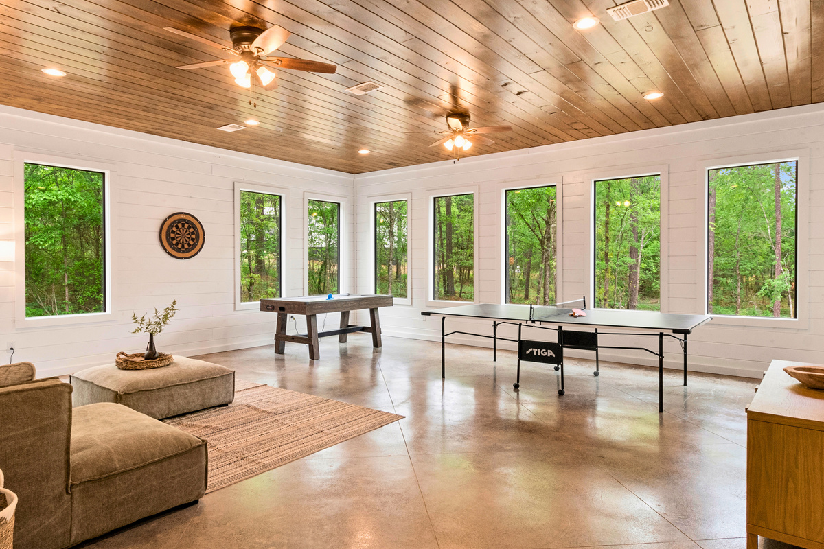 Challenge your friends and family to an air hockey duel or a ping pong match in this game room, surrounded by views of nature for a playful escape.