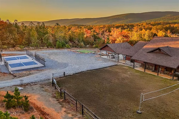 Sport court (pickleball net, basketball hoop) and recreation area captured from above.
