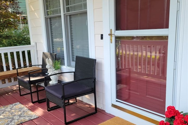 Front port with a couple chairs and also two bences so you can sit in front of the house and enjoy the neighborhhod.