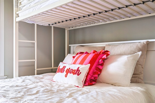 Our basement’s first bedroom is ready for you, with two queen-sized beds and two twin beds, making it great for families or friends.
