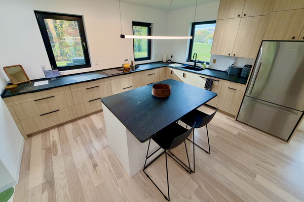 Kitchen includes full size oven, induction cooktop, microwave, air fryer, toaster, coffee maker, and more.