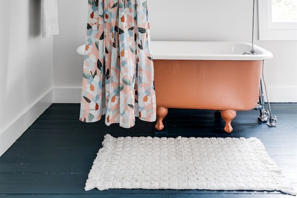 2nd Floor Full Bathroom: Delight in a vintage clawfoot tub and playful floral curtains for a refreshing retreat!